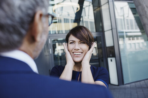 Excited woman looking at businessman - RORF00422