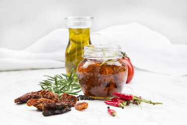 Glass of pickled dried tomatoes and ingredients - LVF05542
