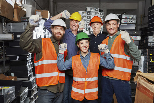 Workers in computer recycling plant cheering - RKNF00380