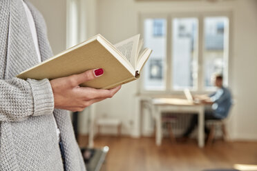 Hands of woman holding open book - FMKF03133