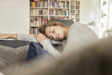 Young woman relaxing with eyes closed on couch in the living room - FMKF03143