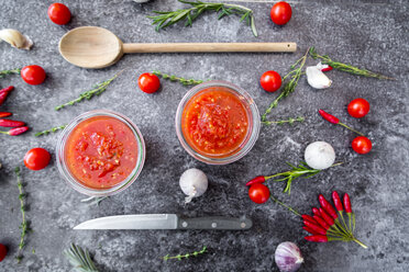 Two glasses of homemade tomato sauce and ingredients on stone - SARF03037