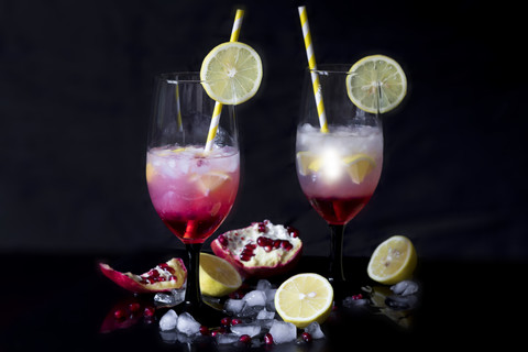 Two glasses of Gin Daisy and ingredients in front of black background stock photo