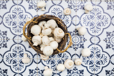 Wickerbasket of organic champignons on tiles - LVF05564