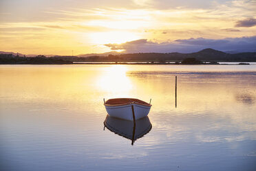 Italy, Sardinia, Murta Maria, boat on the water at sunset - MRF01674