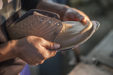 Shoemaker working on shoe in workshop - ZEF11283