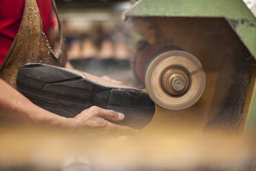 Shoemaker working on shoe in workshop - ZEF11287