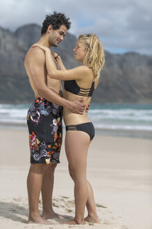 Tender young couple standing on the beach - ZEF11319