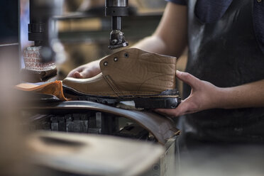 Shoemaker working on shoe in workshop - ZEF11333
