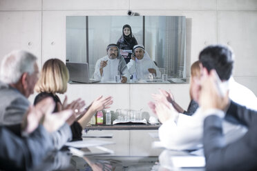 Business people in video conference with clients from the Middle East - ZEF11457