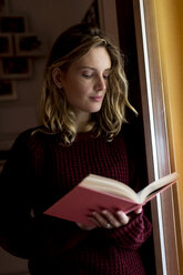 Frau liest ein Buch zu Hause - MAUF00871