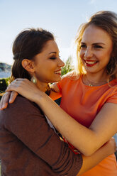 Two happy friends embracing on roof terrace - AIF00420