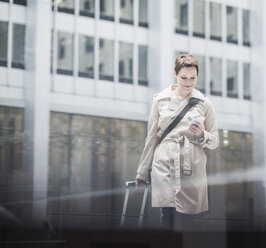 USA, New York City, businesswoman in Manhattan on the go with cell phone - UUF08942