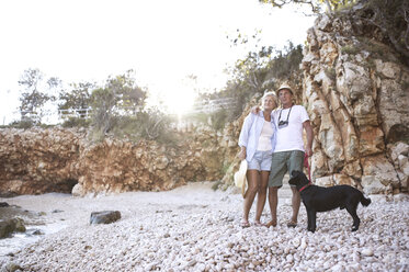 Happy senior couple with dog on the beach - HAPF01026