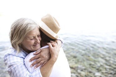 Happy senior couple hugging in front of the sea - HAPF01044