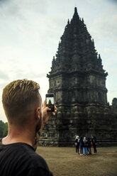 Indonesia, Java, Tourist photographing Prambanan temple - KNTF00575