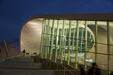 Netherlands, Arnheim, lighted glass facade of central station by night - BSC00552