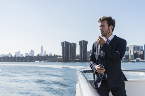 USA, New York City, businessman telephoning on ferry on East River stock photo