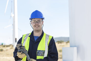 Engineer at wind farm holding wrench - ZEF11516