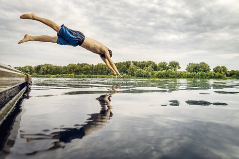 Man jumping from jetty into water - BMAF00279