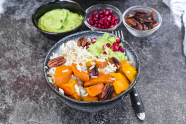 Bowl of autumnal salad with carrots, pumpkin, sweet potatoes, pecan, guacamole, pomegranate and rice - SARF03056