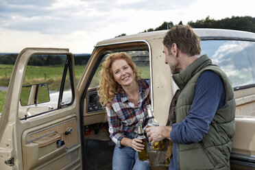 Couple at pick up truck with beer bottles - FMKF03162