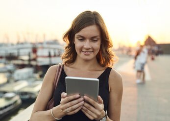 Germany, Hamburg, Young woman using digital tablet - WHF00009