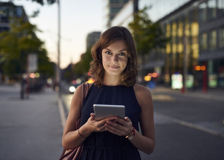 Deutschland, Hamburg, Junge Frau auf der Straße mit digitalem Tablet - WHF00034