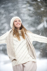 Portrait of smiling blond woman wearing knitwear in winter - HHF05472