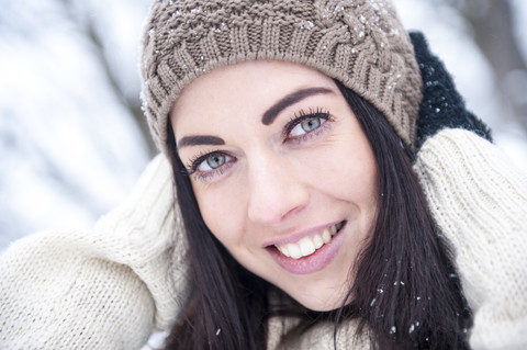 Portrait of smiling woman wearing knitwear in winter stock photo