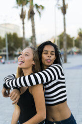 Two playful young women on square - KKAF00024
