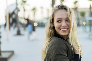 Portrait of happy young woman outdoors - KKAF00025