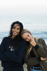 Portrait of two happy young women on the beach - KKAF00030