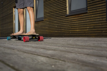 Beine eines Jungen, der auf seinem Skateboard steht - JTLF00121