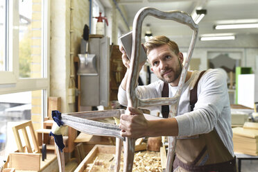 Carpenter restoring a wooden chair - LYF00680