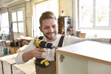 Carpenter assembling furniture in his workshop - LYF00681