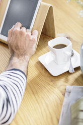 Close-up of man using tablet on table - MADF01186