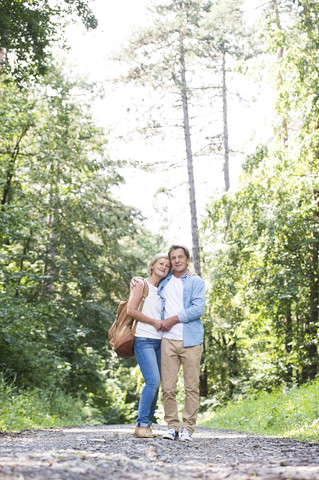 Happy senior couple relaxing together in the woods stock photo