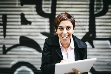 Portrait of happy woman with tablet - JRFF01013