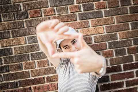 Portrait of woman making a finger frame stock photo