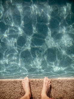 Man standing at pool edge - BMAF00289