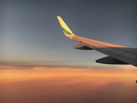 Airplane wing over clods at sunset - BMAF00299