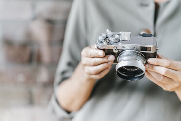 Woman holding camera - KNSF00523