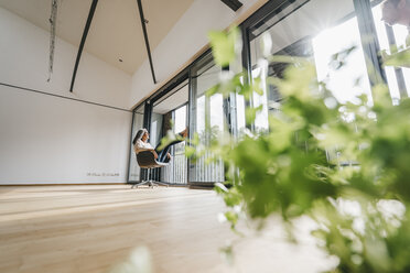 Woman sitting on chair at the window - KNSF00547