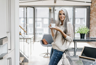 Smiling woman with long grey hair drinking coffee - KNSF00551