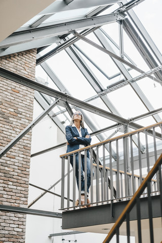 Confident businesswoman with long grey hair in a loft stock photo