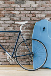 Bicycle and body oard at brick wall - KNSF00579