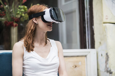 Redheaded woman wearing Virtual Reality Glasses - TAMF00779