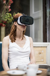 Redheaded woman wearing Virtual Reality Glasses - TAMF00780