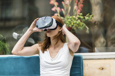 Redheaded woman wearing Virtual Reality Glasses - TAMF00783